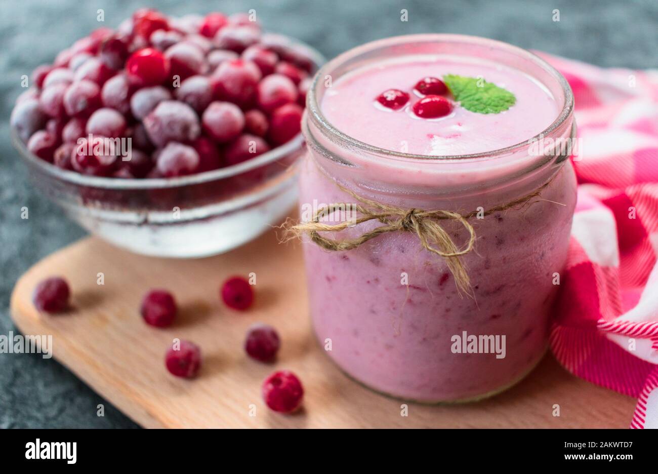 Frozen cranberry yogurt on a black background. The concept of healthy desserts. Close-up. Stock Photo