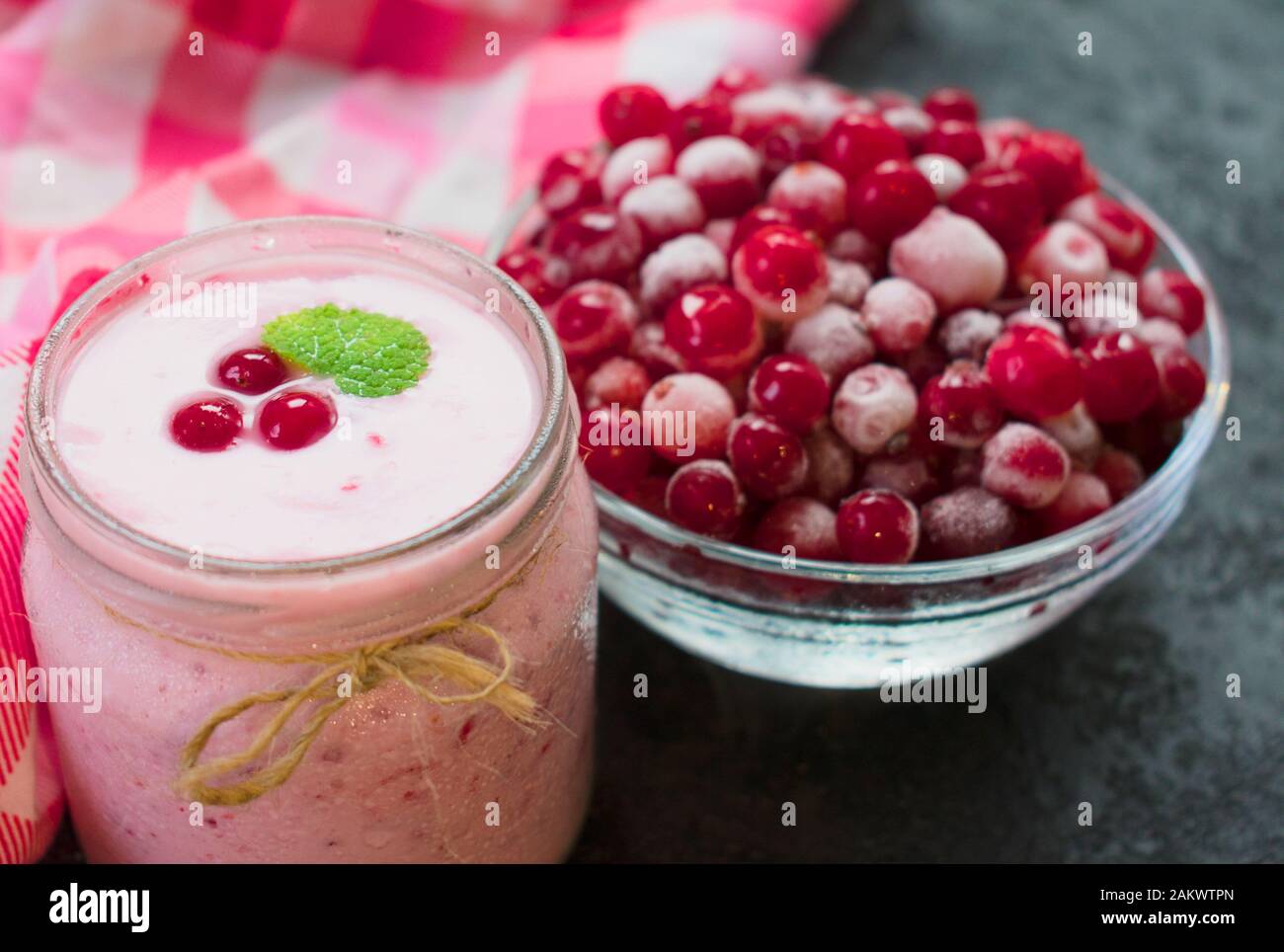 Frozen cranberry yogurt on a black background. The concept of healthy