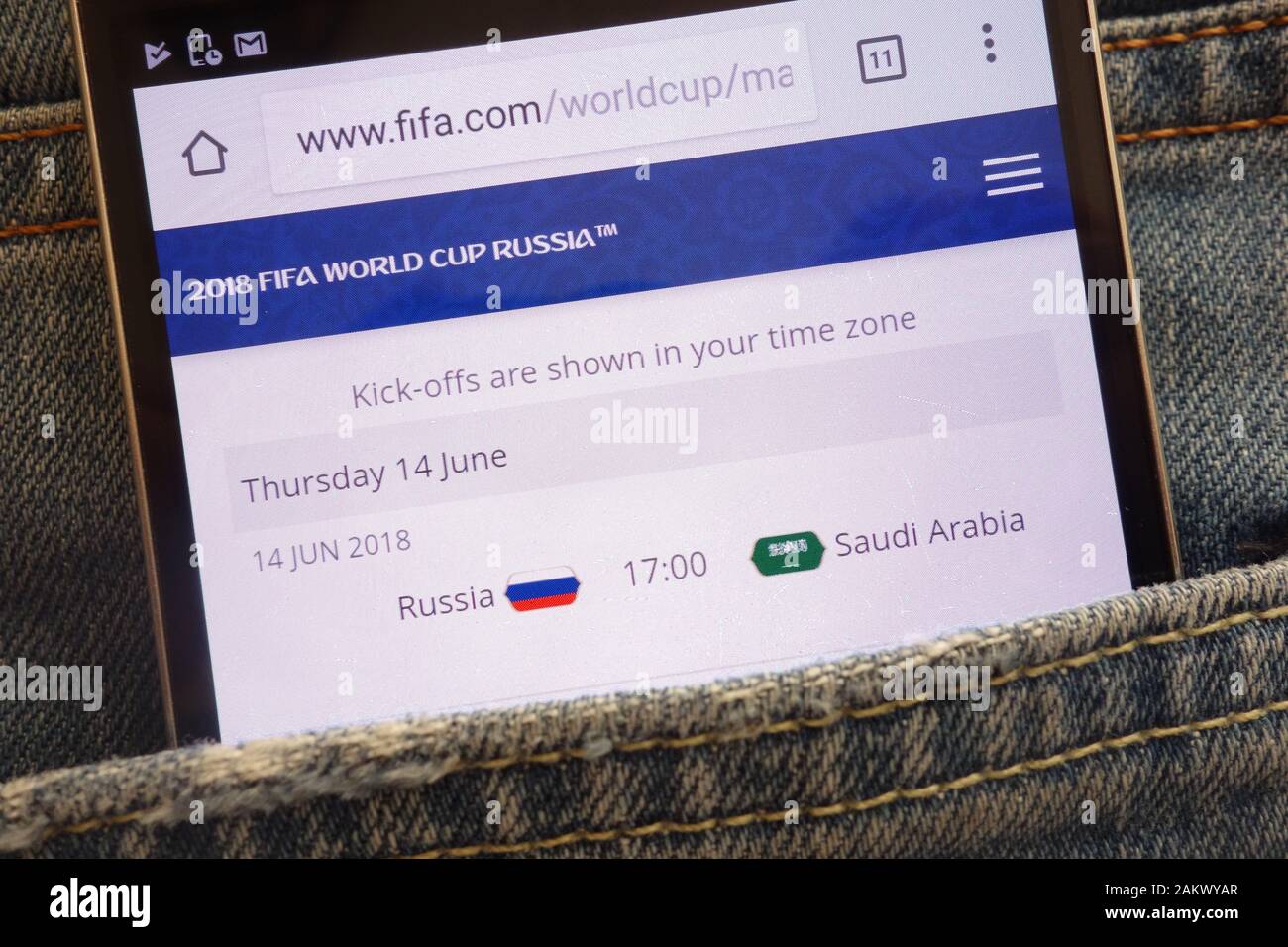 Informations about World Cup 2018 in Russia on the official Fifa website displayed on smartphone hidden in jeans pocket Stock Photo