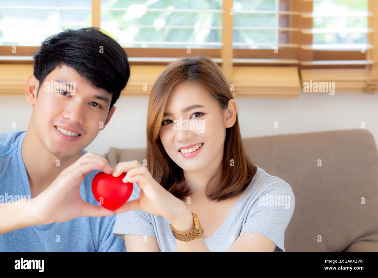 Beautiful portrait young asian couple gesture holding heart shape ...