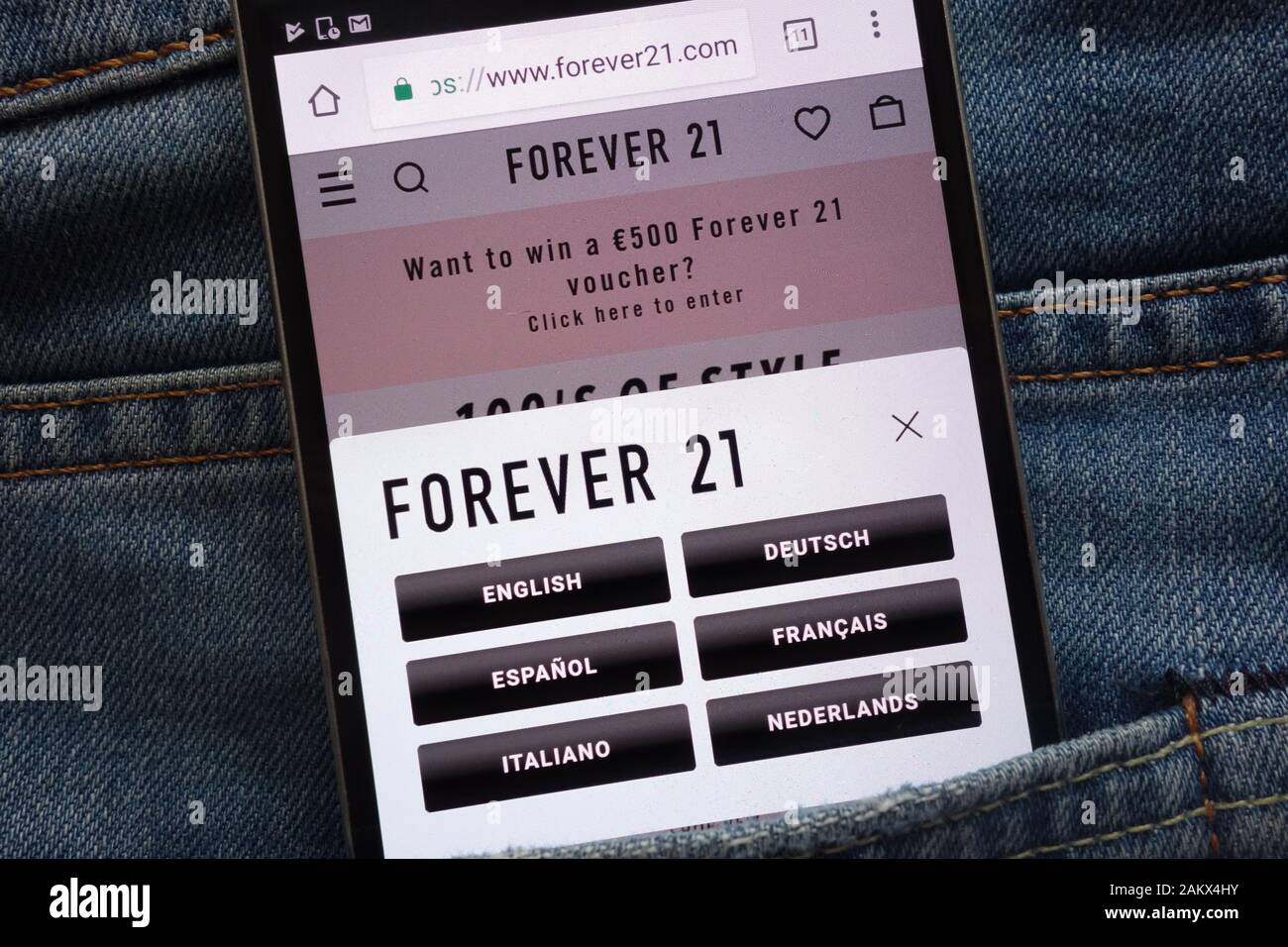 Forever 21 website displayed on smartphone hidden in jeans pocket Stock