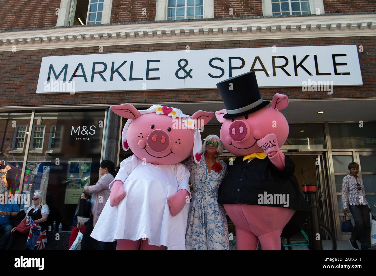Royal Wedding Day, Windsor, Berkshire, UK. 19th May, 2018.  Marks & Spencer in Peascod Street put up a special Markle & Sparkle sign on the outside of their shop and had Percy Pig characters delighting the crowds on the day of the Royal Wedding of Prince Harry and Meghan Markle. Credit: Maureen McLean/Alamy Stock Photo