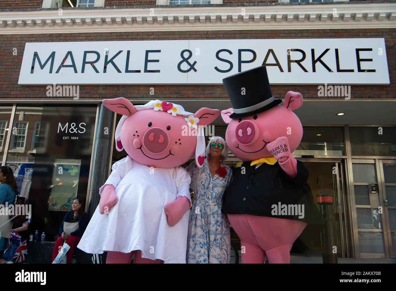 Royal Wedding Day, Windsor, Berkshire, UK. 19th May, 2018.  Marks & Spencer in Peascod Street put up a special Markle & Sparkle sign on the outside of their shop and had Percy Pig characters delighting the crowds on the day of the Royal Wedding of Prince Harry and Meghan Markle. Credit: Maureen McLean/Alamy Stock Photo