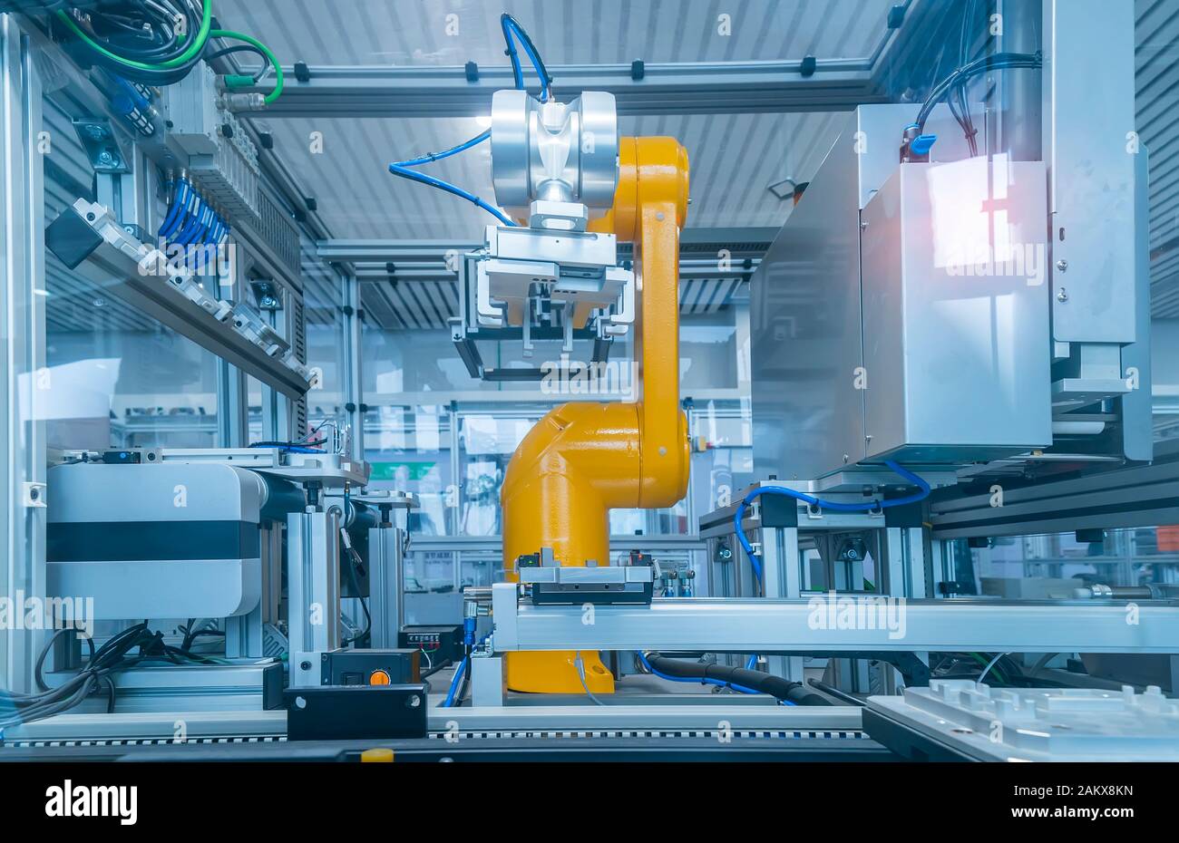 robotic arm catch for electronic assembly line. The robot for smart technology manufacturing process. Stock Photo