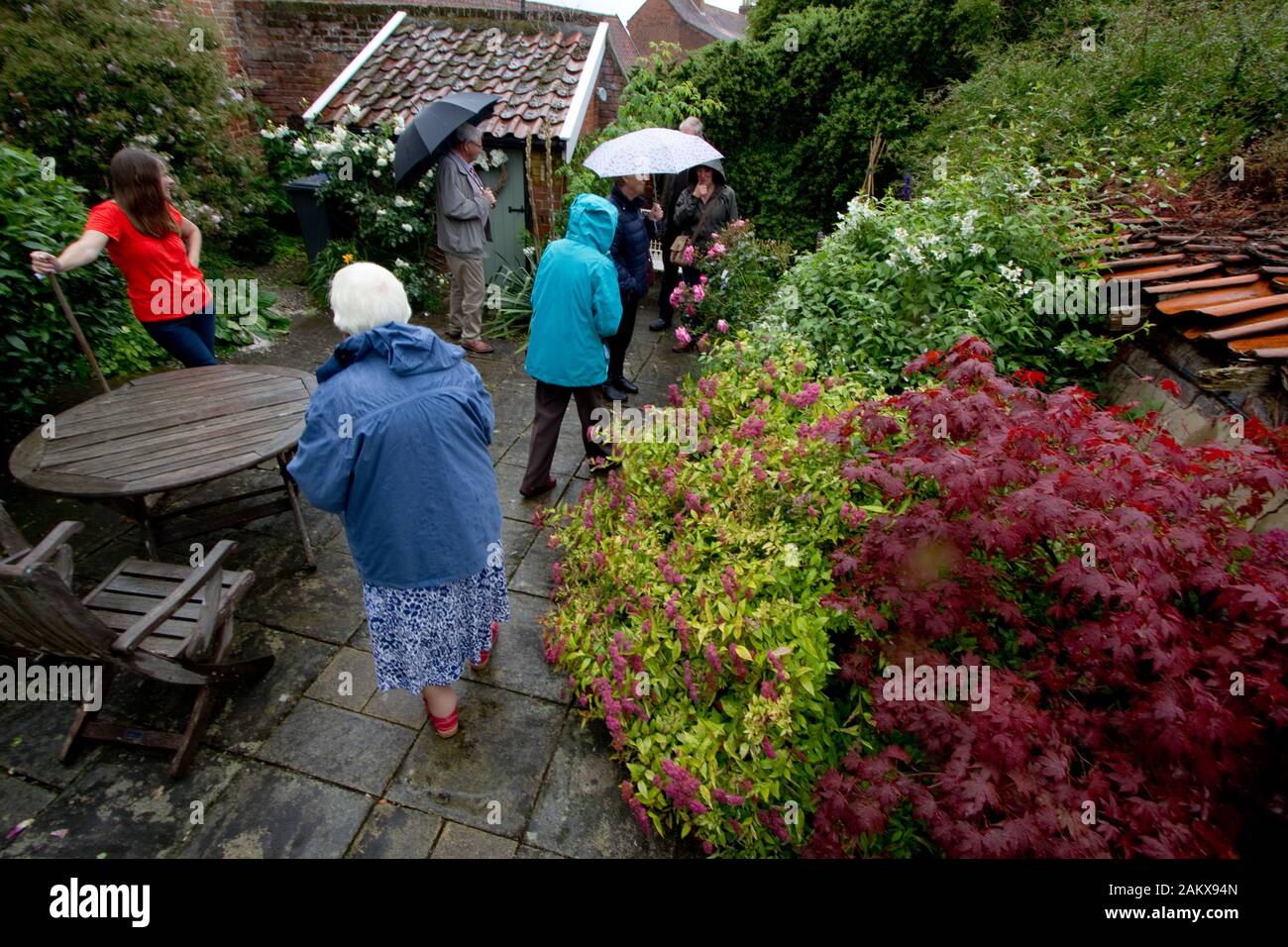 Visitors on a rainy day in a garden open for charity Stock Photo