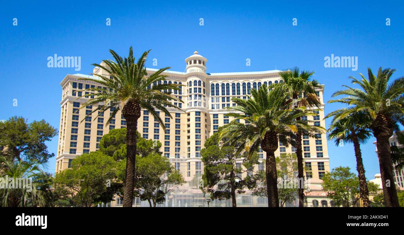 Las Vegas, Nevada, USA - Panorama of the Bellagio Resort exterior surrounded by palm trees with fountain in the foreground. Stock Photo