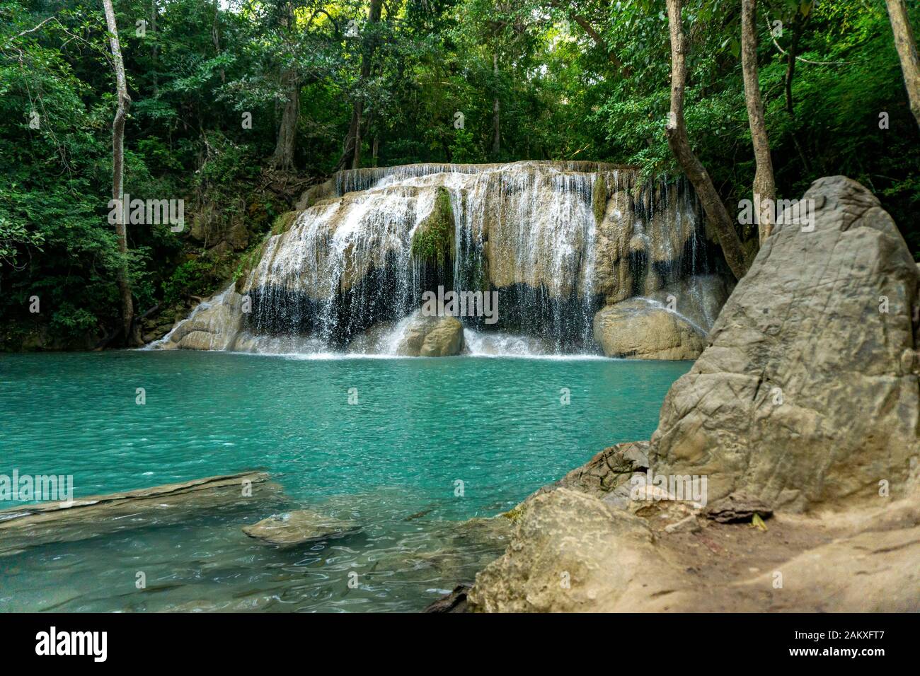 Clean green emerald water from the waterfall Surrounded by small trees - large trees,  green colour, Erawan waterfall, Kanchanaburi province, Thailand Stock Photo