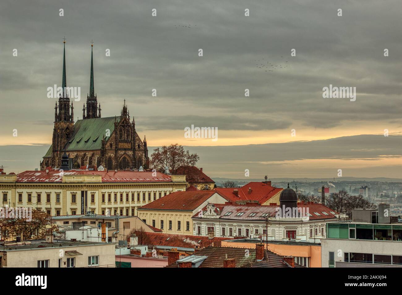Brno Czech Republic January 10 of 2020 - Cathedral of St. Peter and Paul under autumn clouds with light snow on houses buildings on beautiful sunset Stock Photo