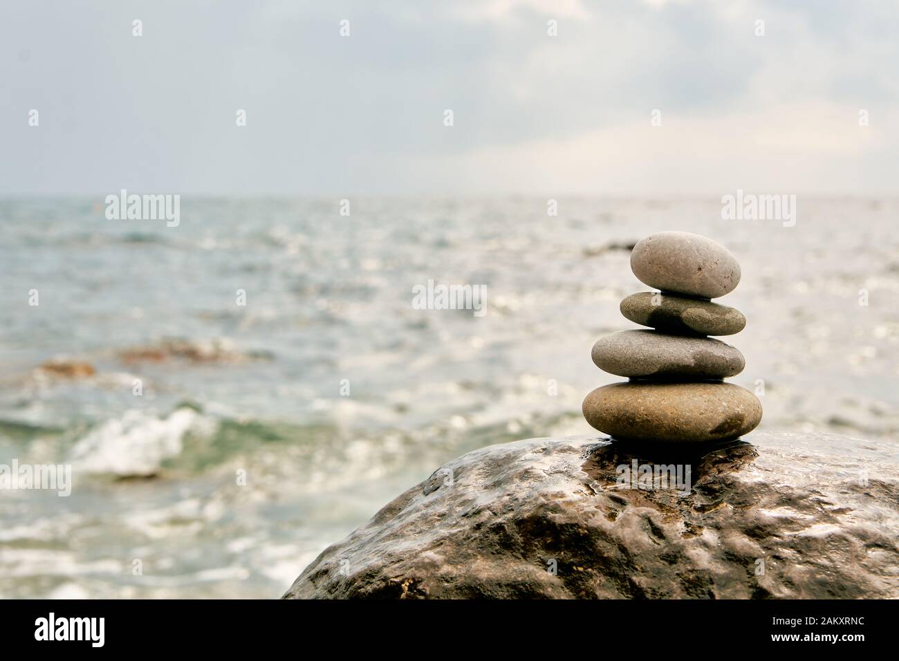 Balance, peace of mind, different sizes stones form a pyramid. Stock Photo