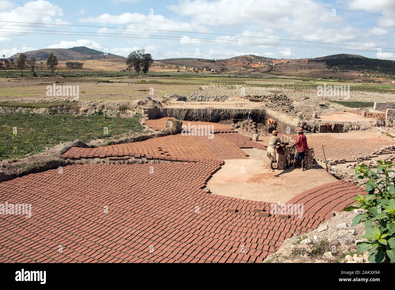 Malagasy people making roof tiles by hand, leaving them to dry in the sun Stock Photo
