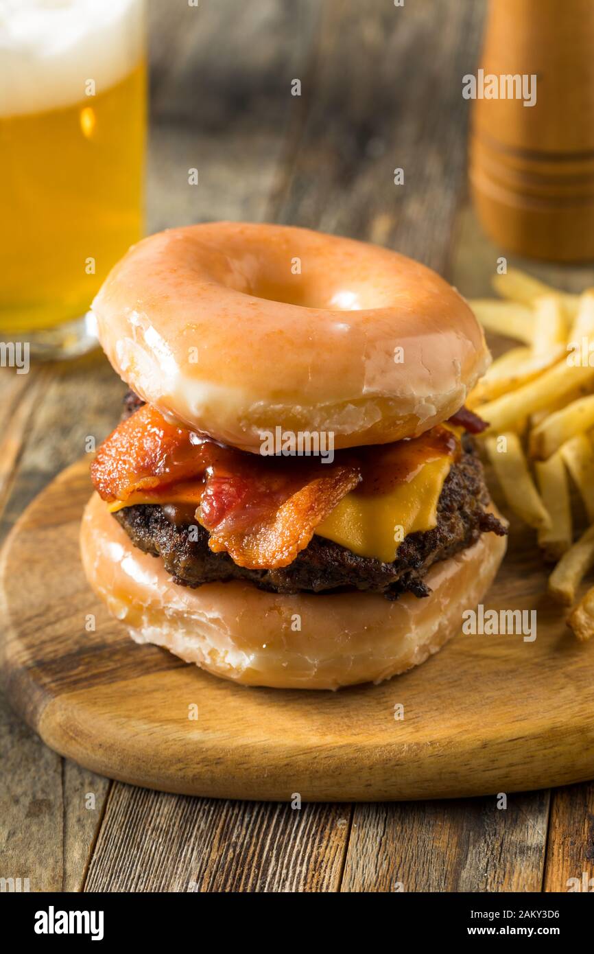 Homemade Donut Cheeseburger with Fries and Beer Stock Photo