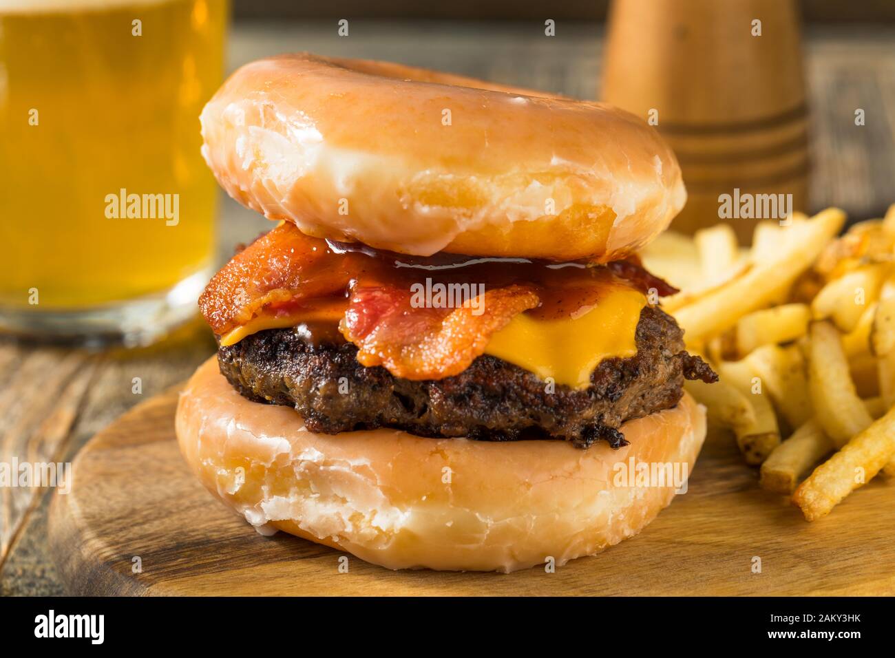 Homemade Donut Cheeseburger with Fries and Beer Stock Photo