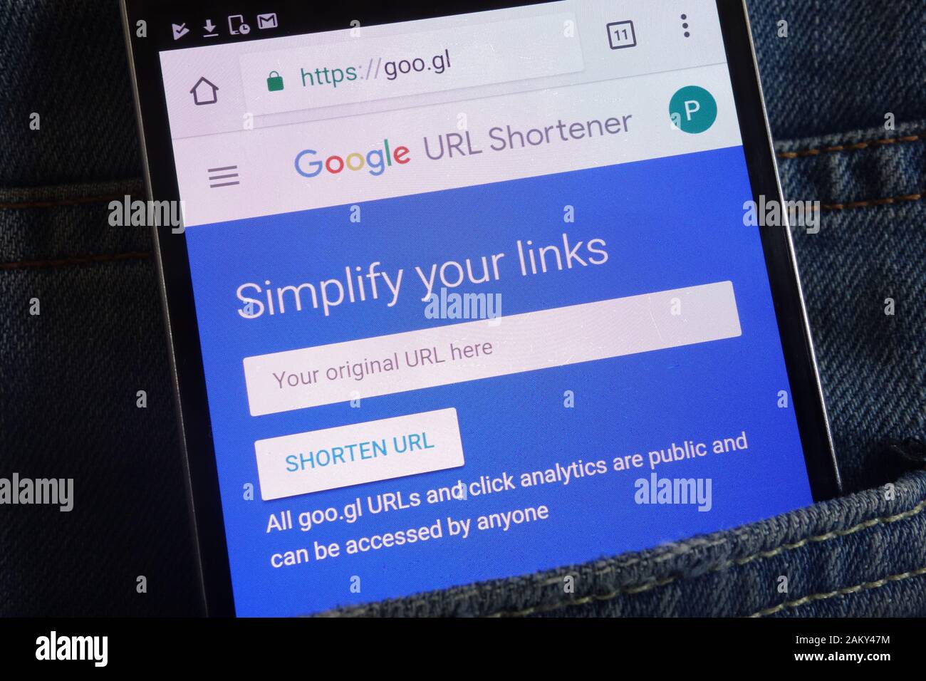 Google URL Shortener website displayed on smartphone hidden in jeans pocket Stock Photo