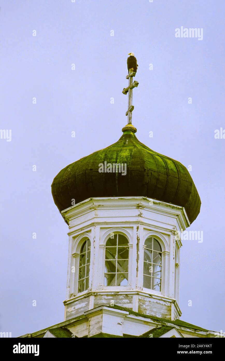 Russian Orthodox Church, Dutch Harbor, Aleutian Islands, Alaska. Built in 1894. Bald eagle sits atop spire. Stock Photo