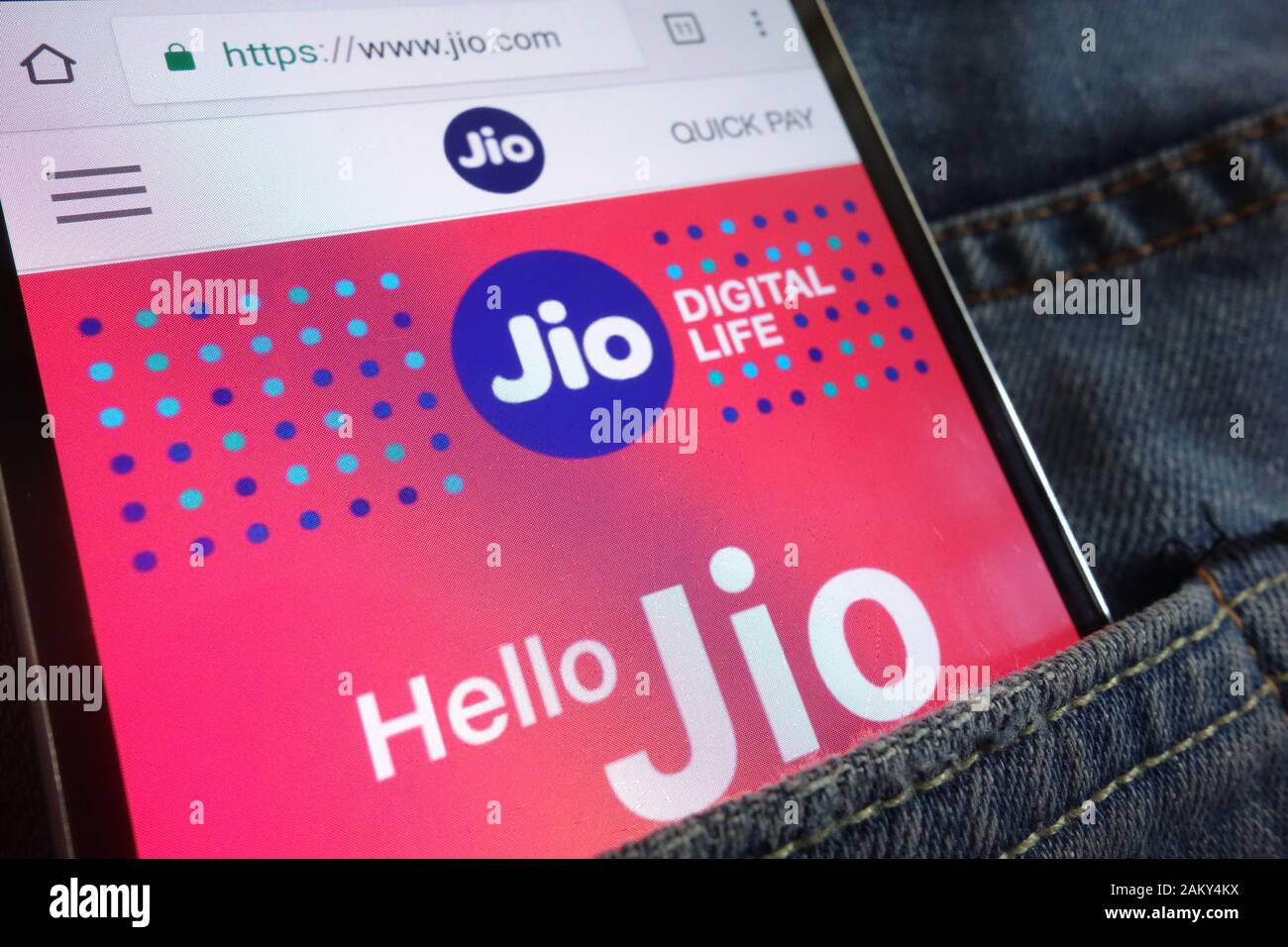 Jio website displayed on smartphone hidden in jeans pocket Stock Photo