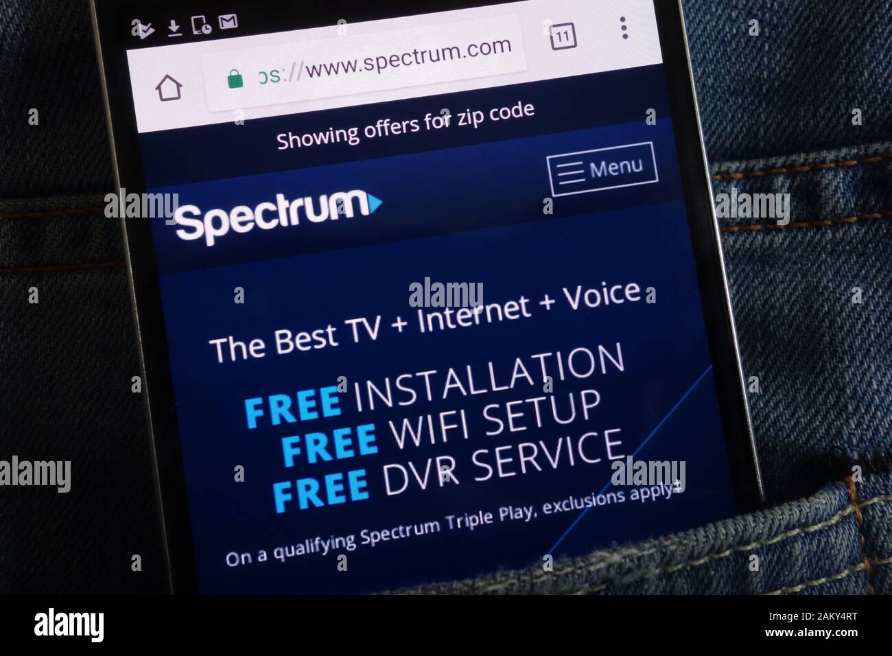 Spectrum website displayed on smartphone hidden in jeans pocket Stock Photo