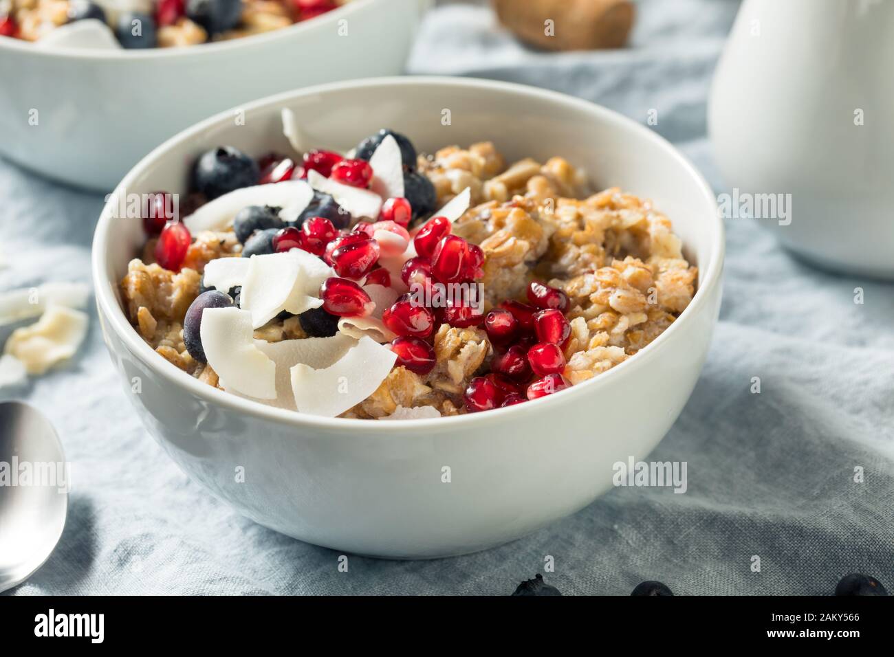 Hot Cooked Muesli Oatmeal with Berries and Coconut Stock Photo