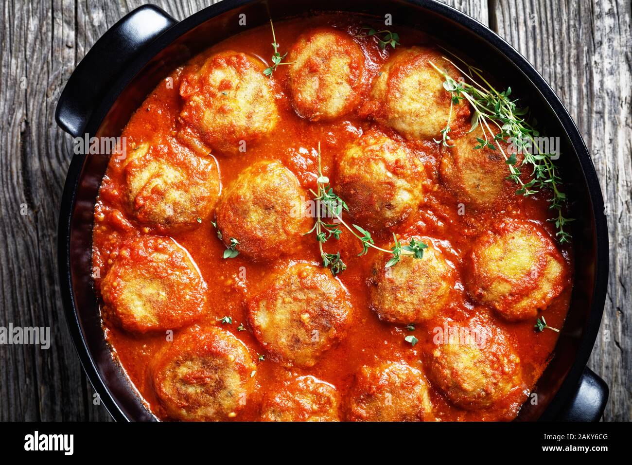 Boulettes de Poisson, Fried Fish Balls in Tomato Sauce in a black dish ...