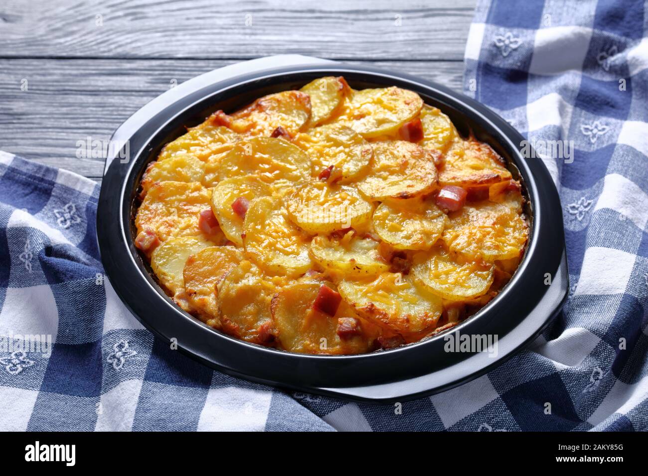 Cheesy Scalloped Potatoes with Ham in a baking dish, horizontal view from above, closeup Stock