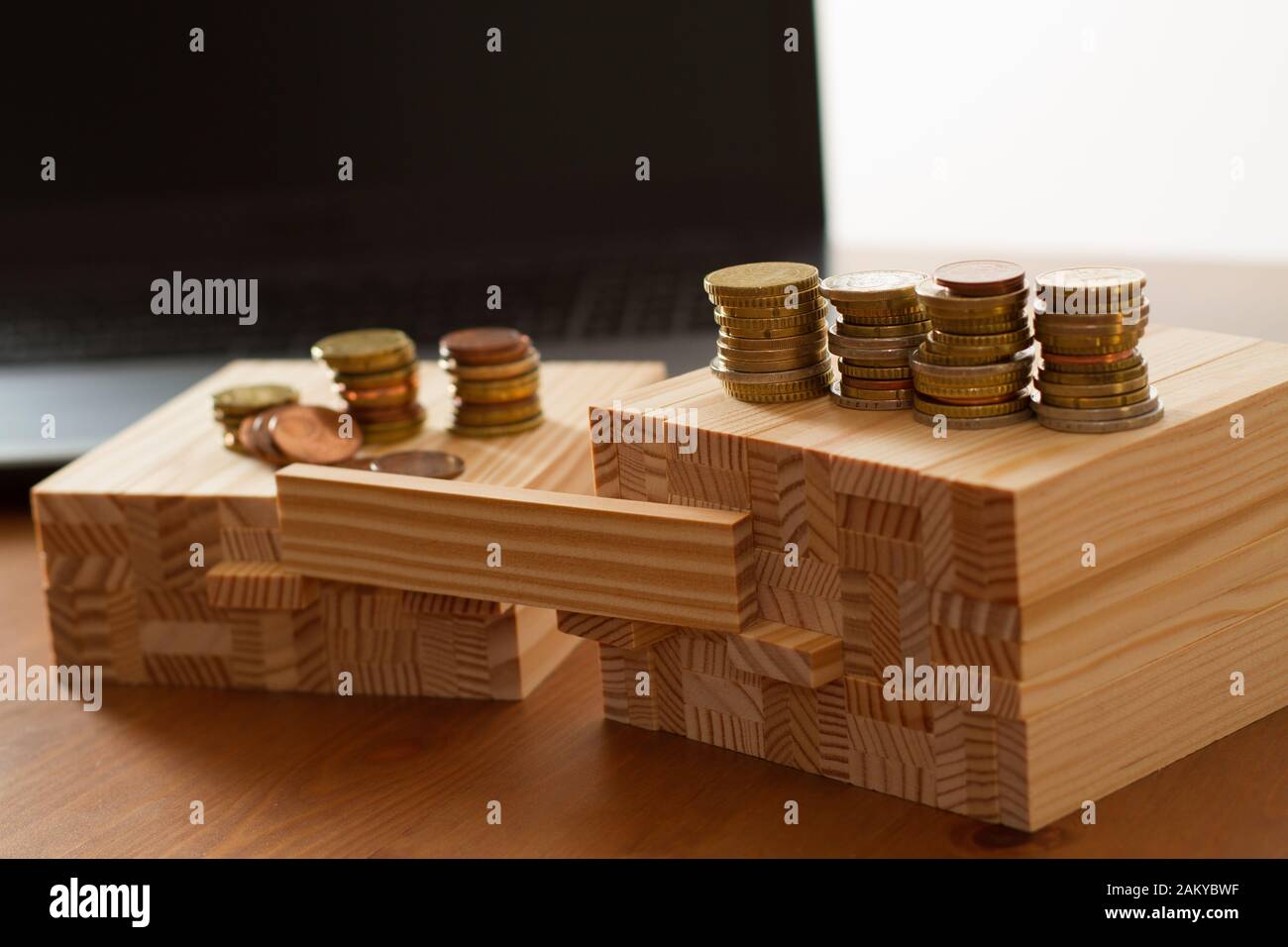 wooden building bricks arranged to symbolize gender gap, discrimination, unequal pay, inequality, or similar business/social Topics with one brick lef Stock Photo