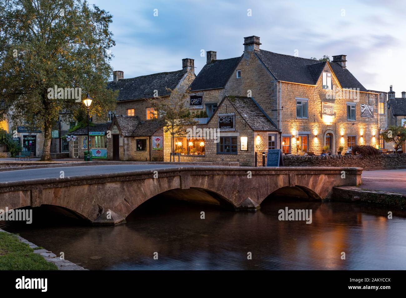 Evening view of Bourton on the Water along River Windrush in the Cotswolds, Gloucestershire, England, UK Stock Photo