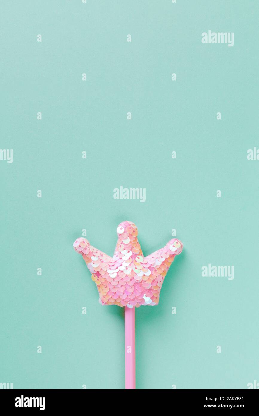 Party, carnival accessory, fairy wand on pastel turquoise background, copy space, flat lay. Minimal style. Vertical. Top view, close-up. For social me Stock Photo