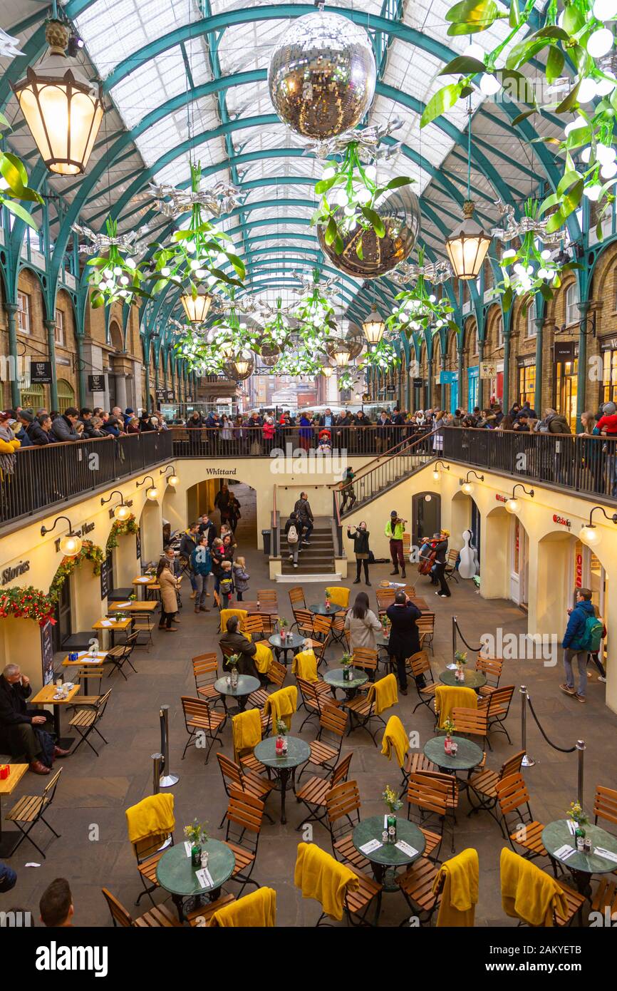 LONDON, UK - December 31, 2019: Covent Garden is one of the major tourist attraction places in London. Shops, pubs, restaurants and street artists mak Stock Photo