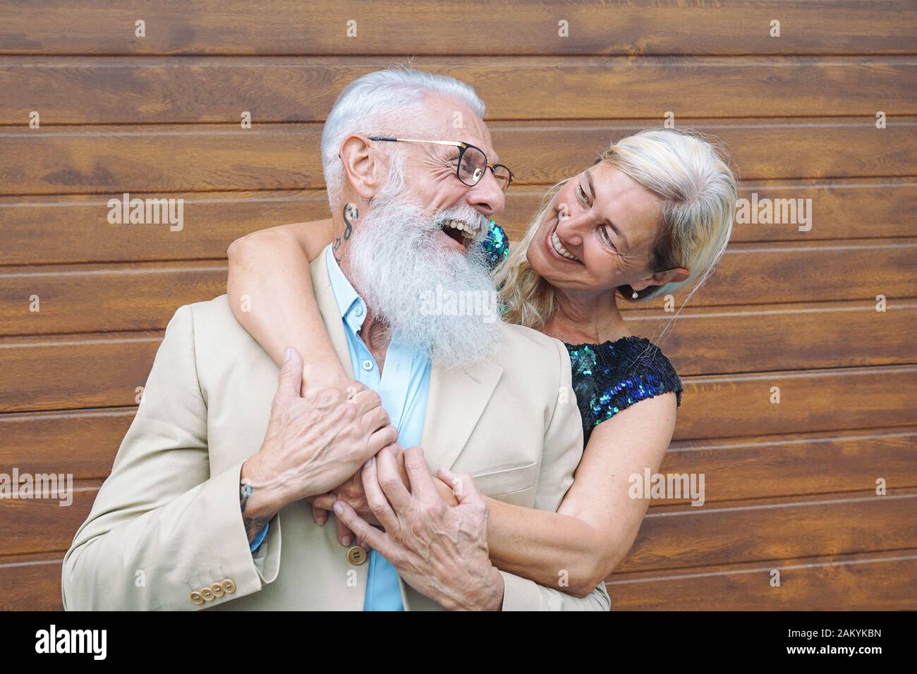 Happy fashion seniors couple embracing outdoor - Mature elegant people laughing and having a tender moment together Stock Photo