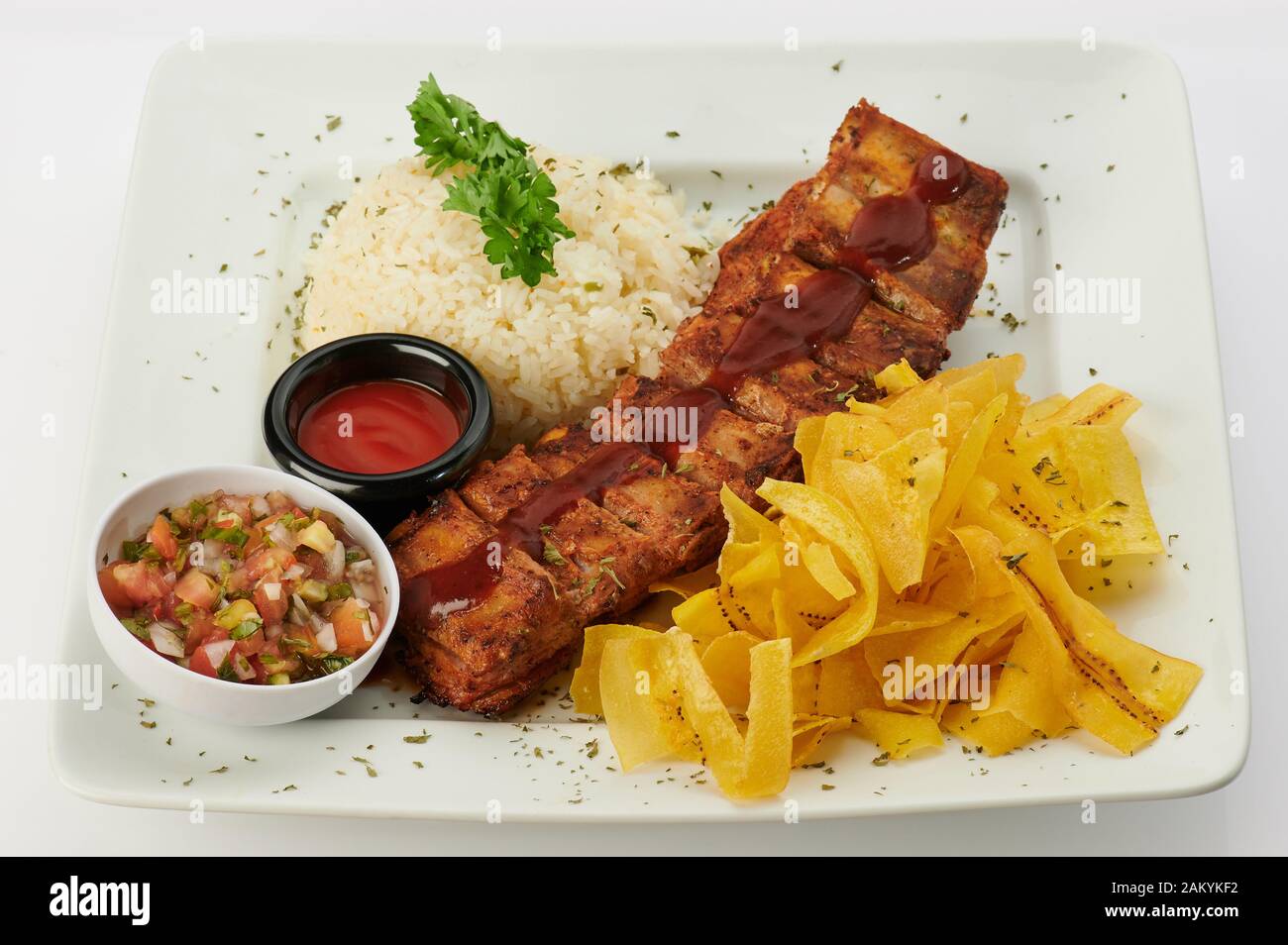 Plate withh bbq ribs and garnish isolated side view Stock Photo