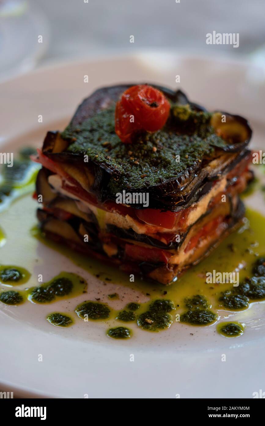 Lunch starter: Aubergine with goats cheese and pesto sauce at the Grand Café de la Poste: Stock Photo