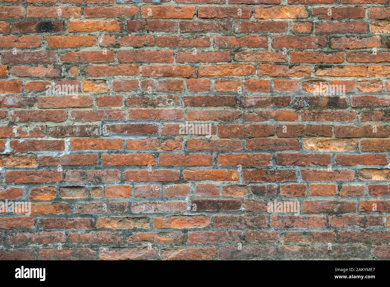 Weathered old red brick background with rough surface. Stock Photo