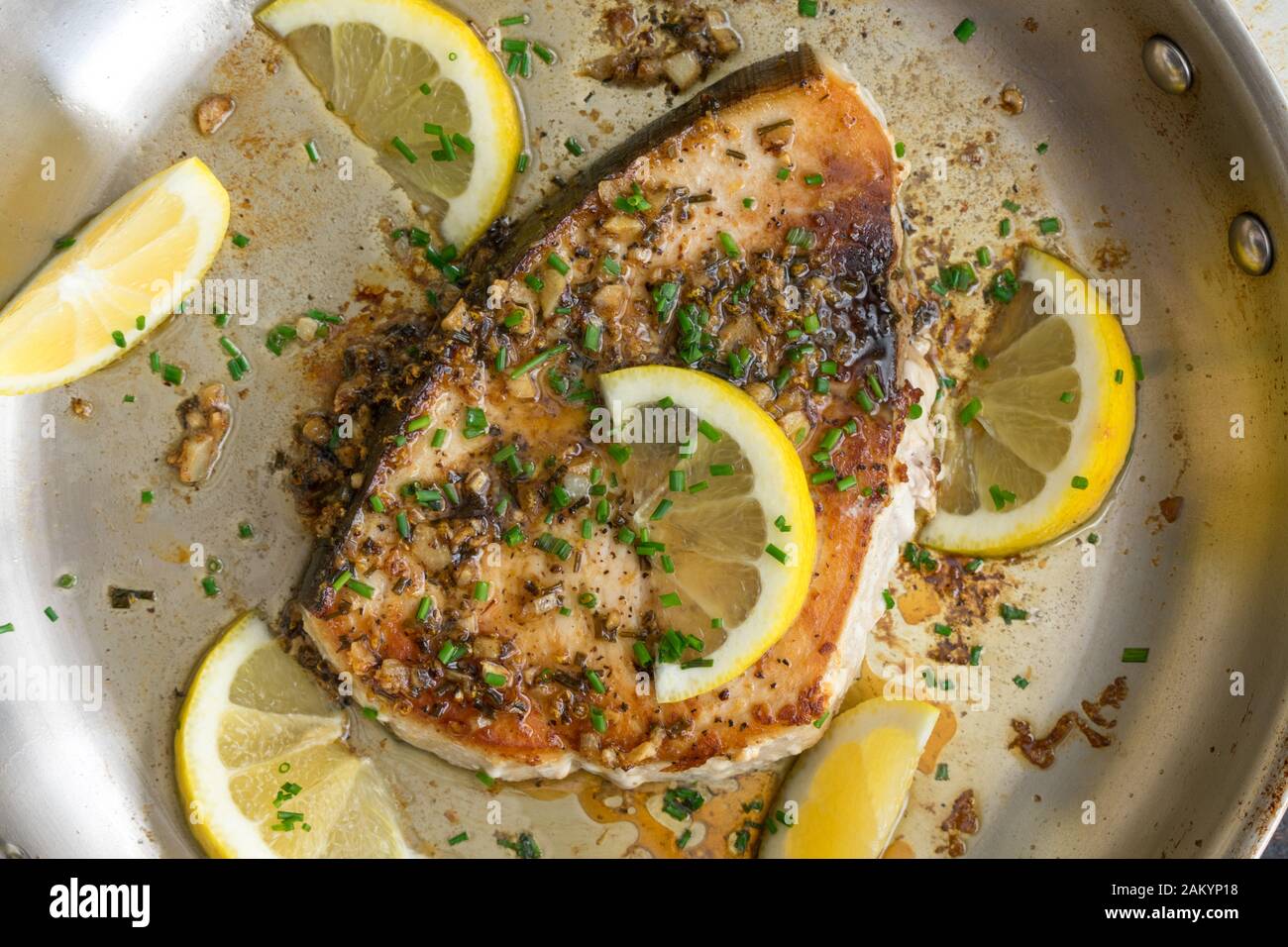 Lemon Garlic Swordfish in a Skillet A panfried swordfish steak in