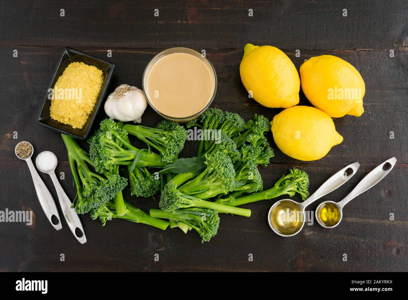 Broccolini with Lemon Tahini Dressing Ingredients: Raw broccolini, lemons, tahini, and other ingredients Stock Photo