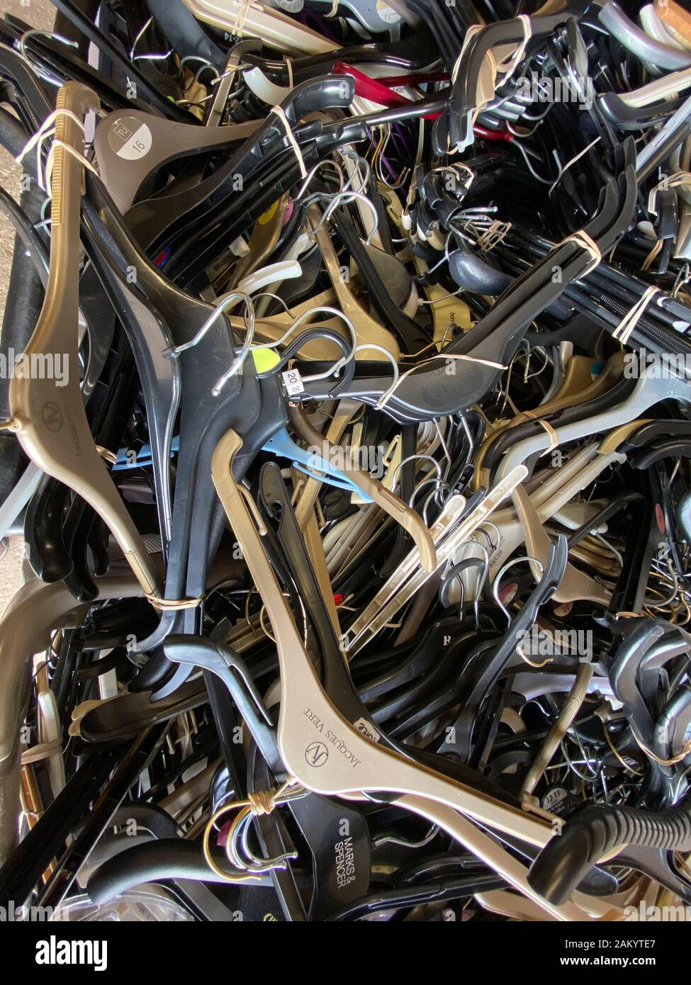 Piles of plastic coat hangers in a waste recycling bin, UK Stock Photo