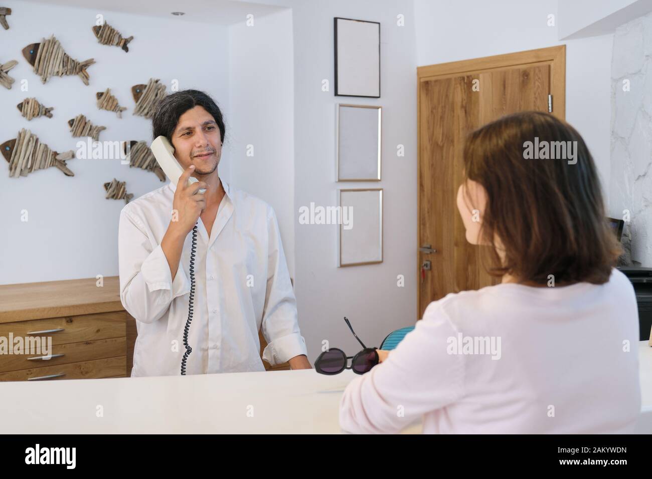 Resort Hotel Front Desk Woman Guest Talking To Man Working At