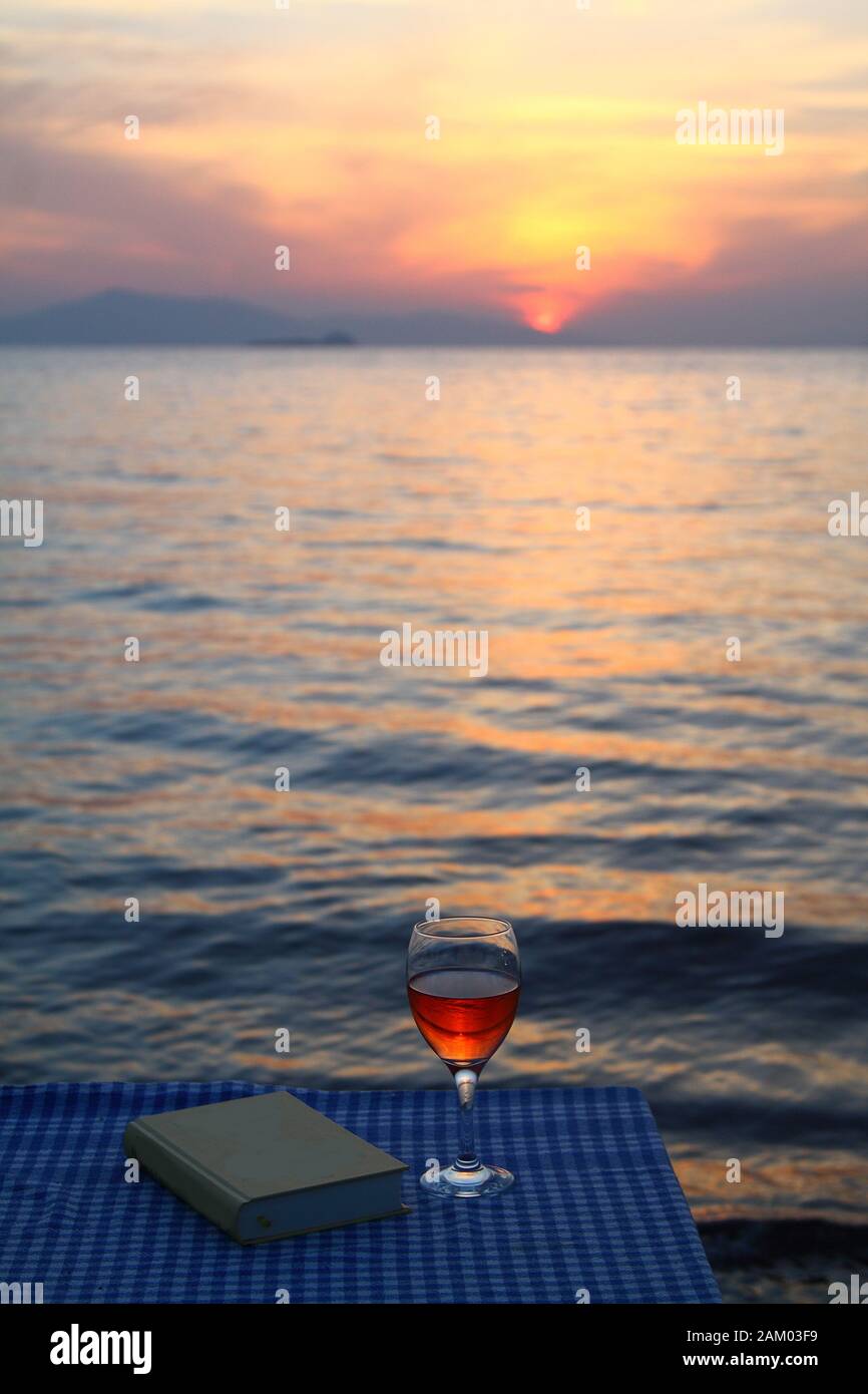 picnic blanket on beach with wine glasses and book Stock Photo Alamy
