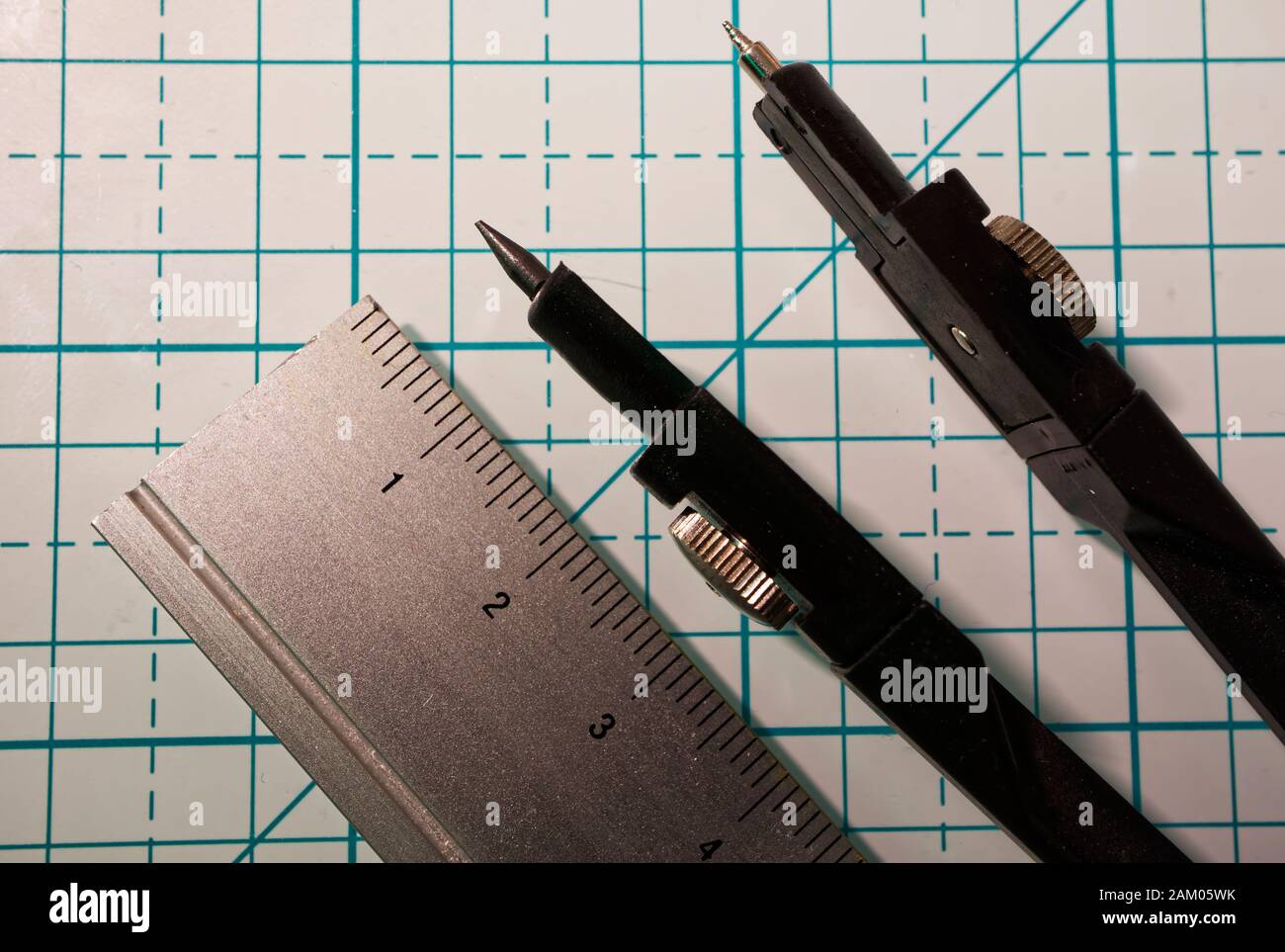 Drawing compass and a ruler on a geometric background. Macro image