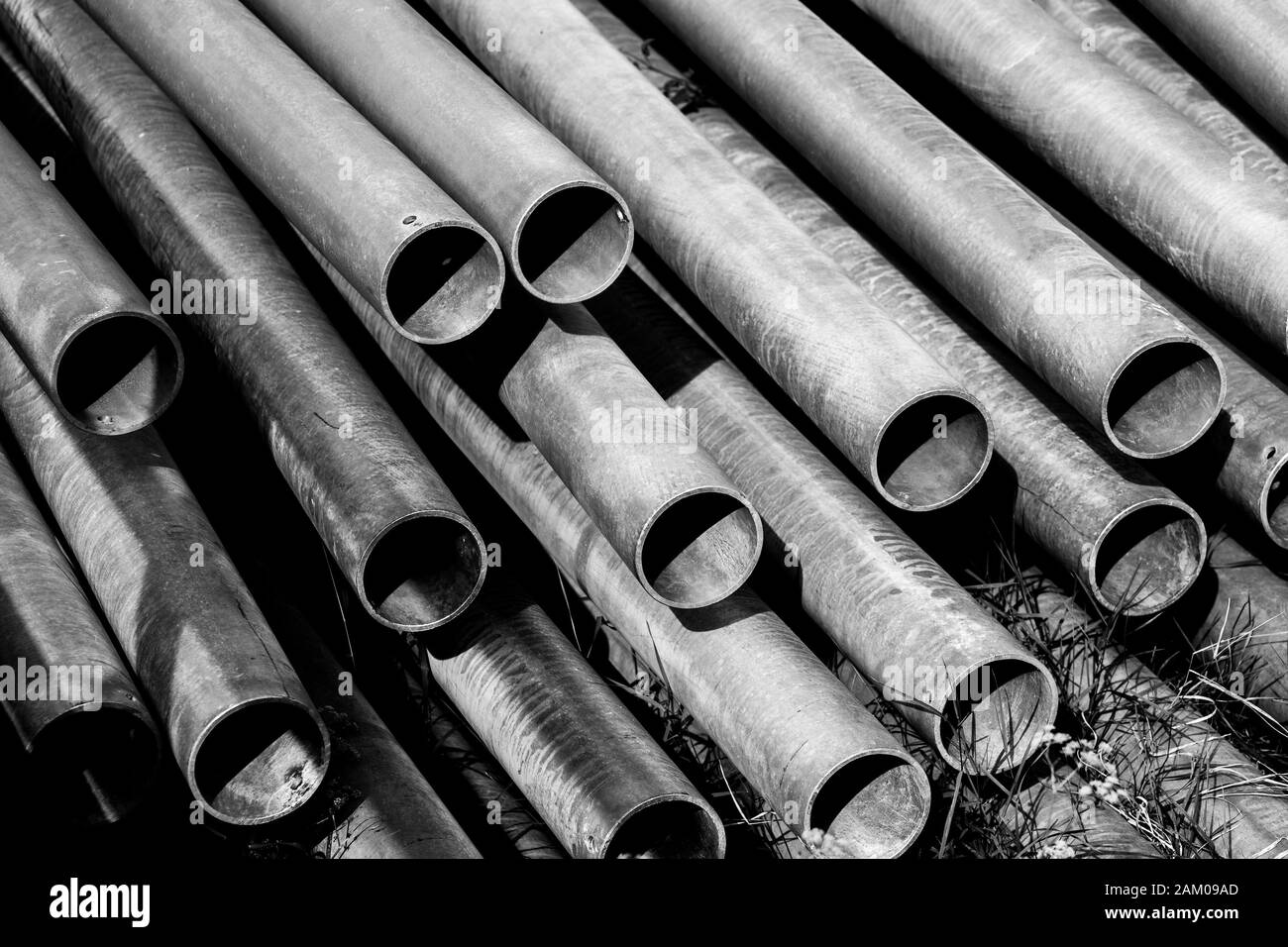 Metal tubes placed on the ground and piled on a stack Stock Photo Alamy