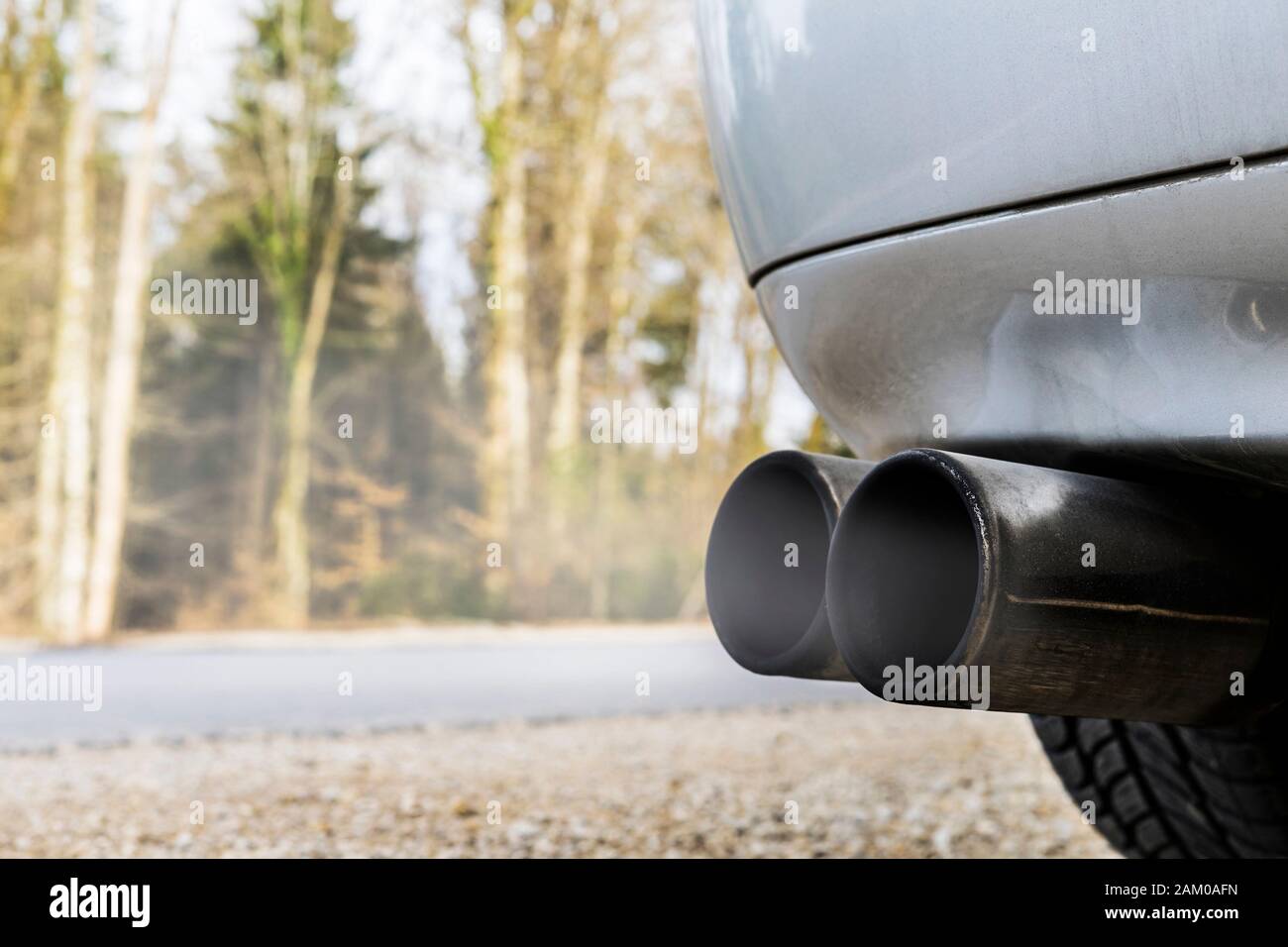 Dark black car exhaust system with smoke Stock Photo Alamy