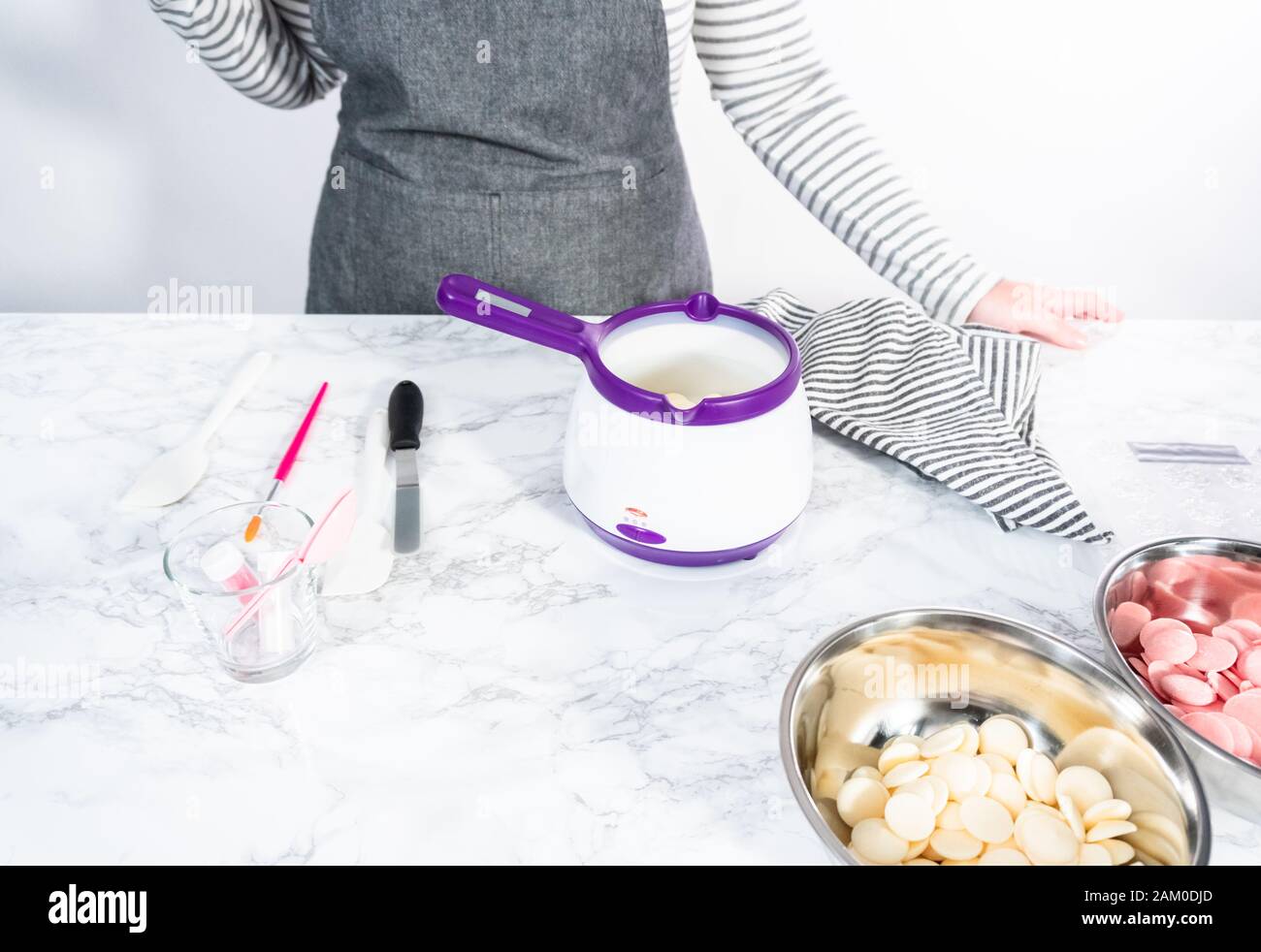 Melting chocolate chips in candy melting pot Stock Photo Alamy