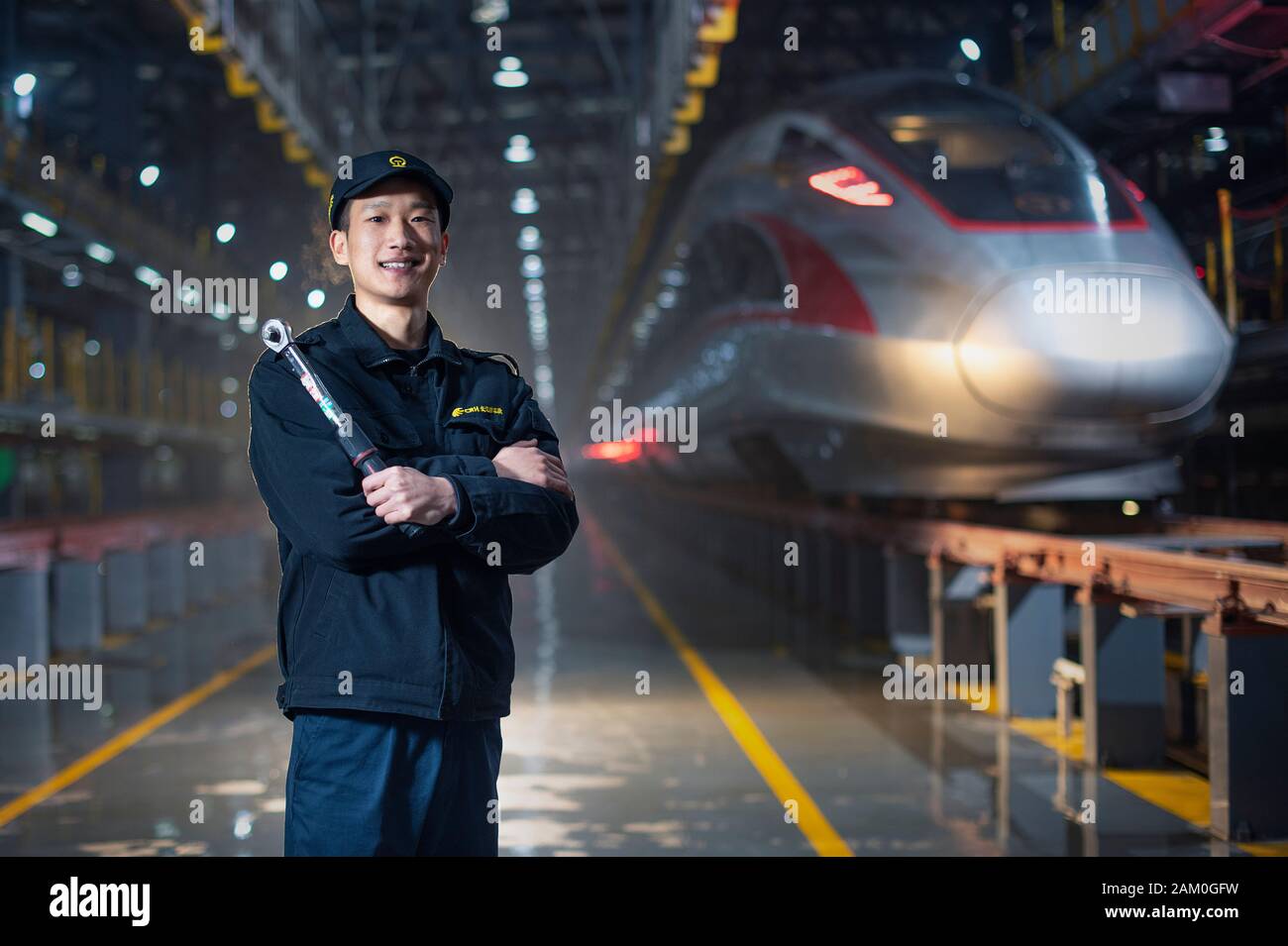 (200111) -- WUHAN, Jan. 11, 2020 (Xinhua) -- Wang Huihui, a mechanician for ground service, poses for a photo at the bullet train overhaul base in central China's Hubei Province, Jan. 3, 2020. China, the world's most populated country, on Jan. 10 ushered in its largest annual migration, 15 days ahead of the Spring Festival, or the Lunar New Year. This year, three billion trips will be made during the travel rush from Jan. 10 to Feb. 18 for family reunions and travel, according to official forecast. The 40-day travel rush is known as Chunyun in Chinese. The Lunar New Year falls on Jan. 25 th Stock Photo