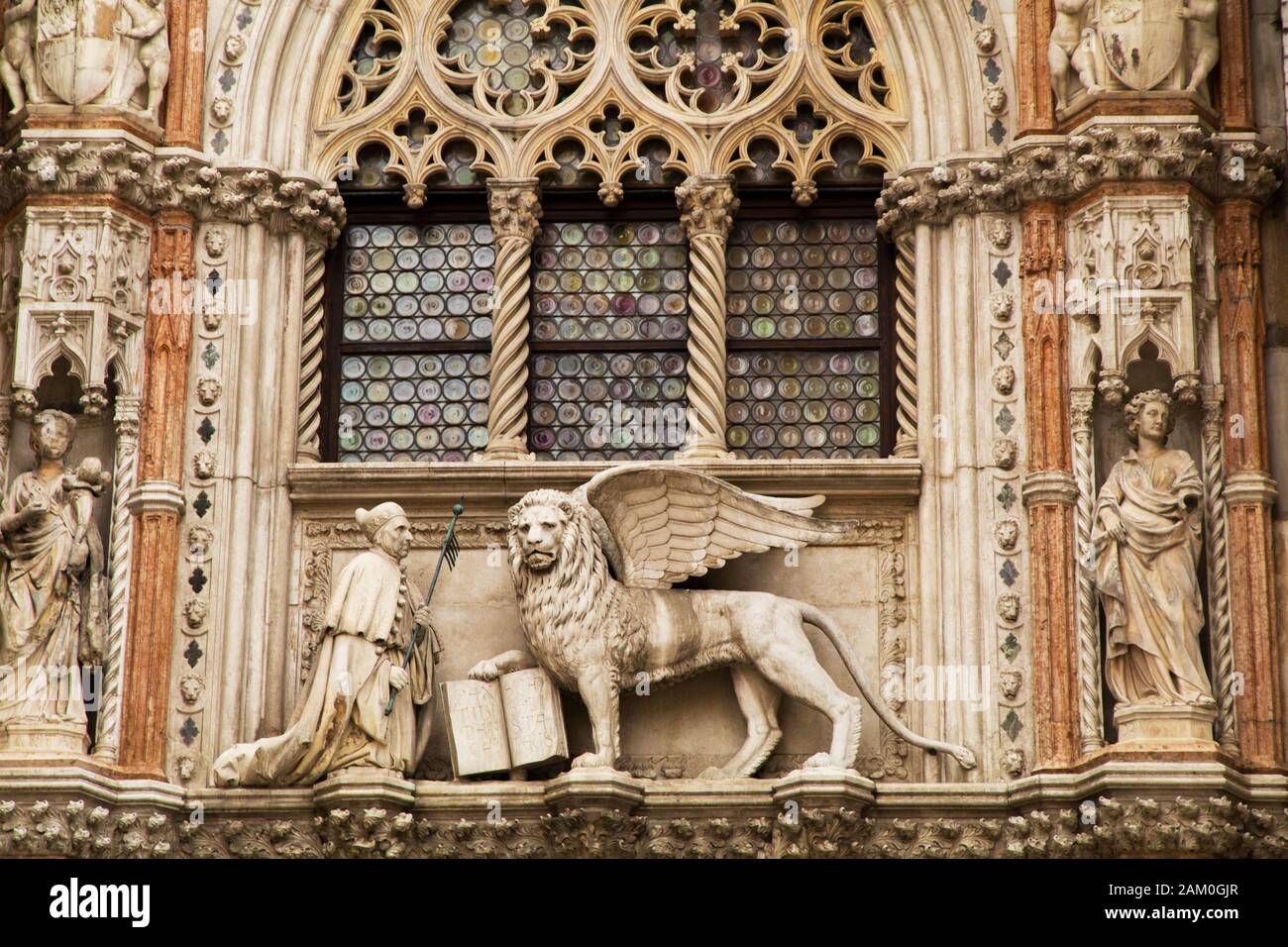 The Porta della Carta with its statue of Doge Foscari and the Lion of St Mark is the entrance to the court of the Palazzo Ducale in Venice Italy Stock Photo