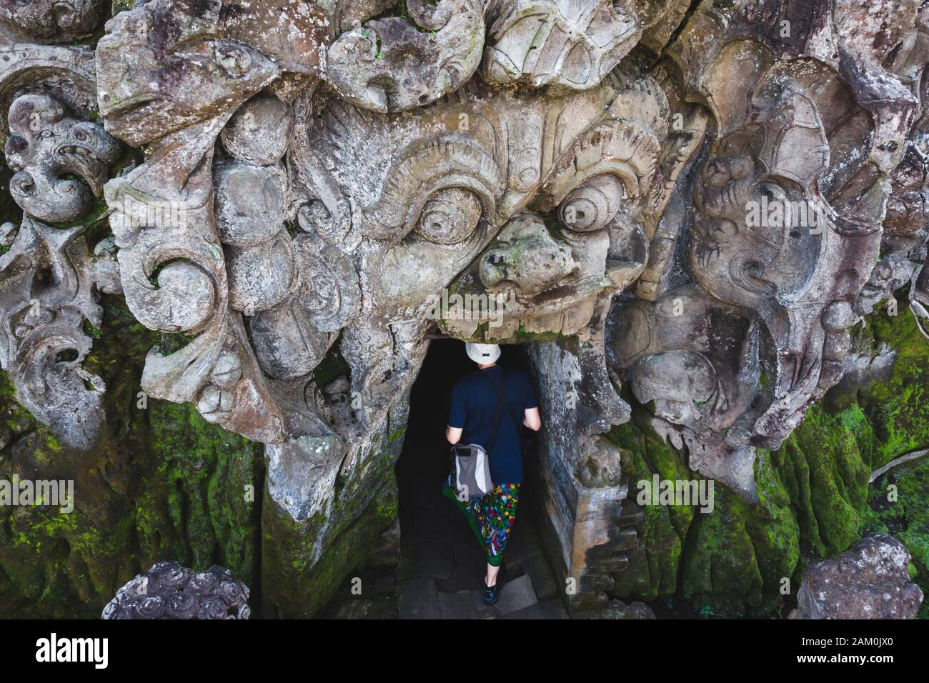 High angle view of tourist entering the ancient Goa Gajah Elephant Cave temple in Ubud, Bali, Indonesia. Stock Photo
