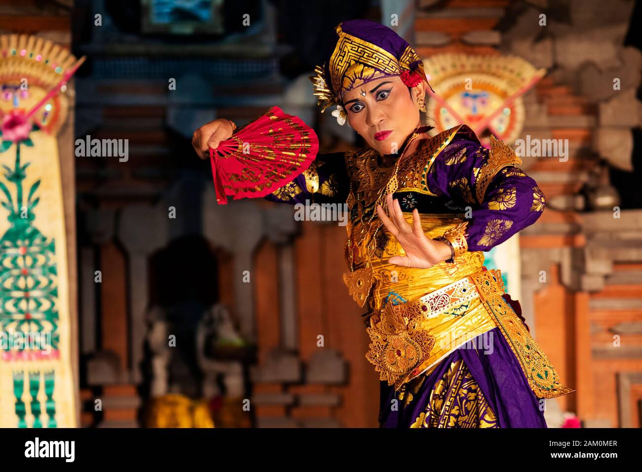 Balinese dancer performing Legong dance wearing traditional costumes at Pura Saraswati temple in Ubud, Bali, Indonesia. Stock Photo