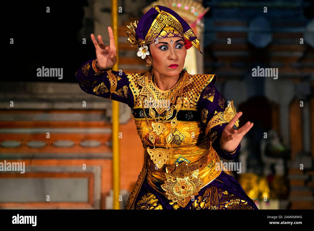 Balinese dancer performing Legong dance wearing traditional costumes at Pura Saraswati temple in Ubud, Bali, Indonesia. Stock Photo