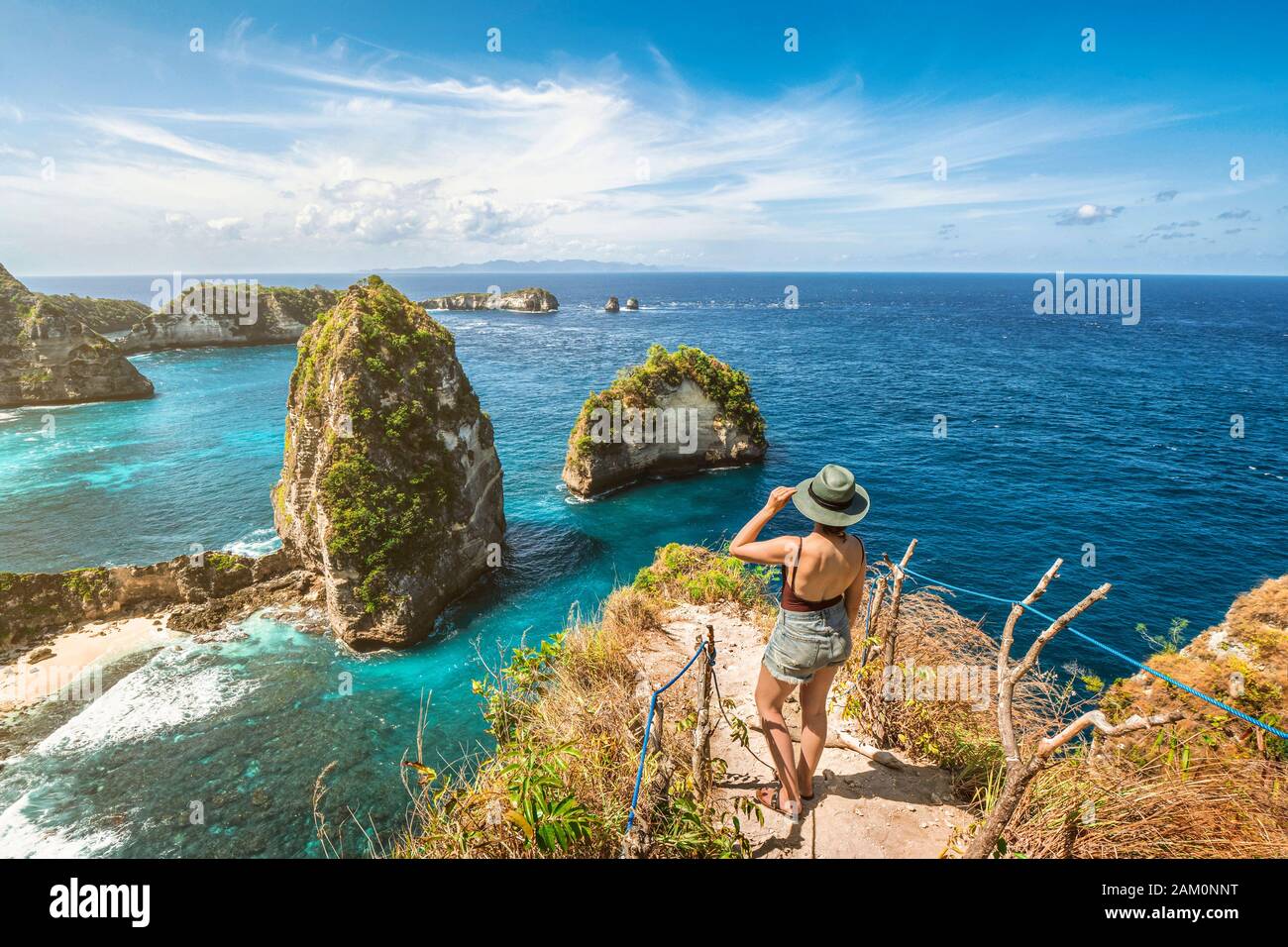 Bali, Indonesia, female traveler exploring Nusa Penida Island at Diamond Beach. Stock Photo
