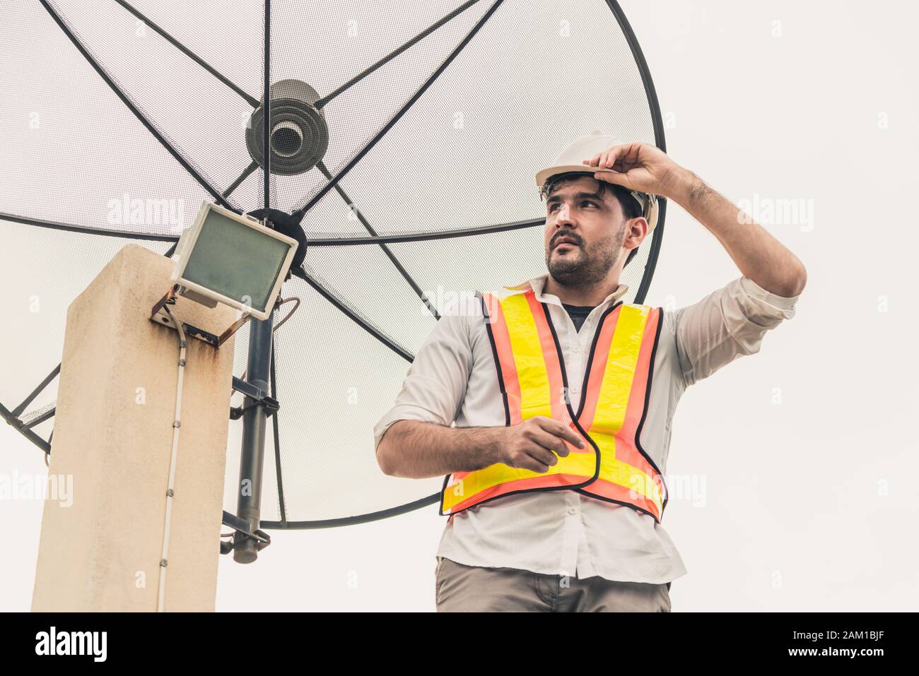 Engineer installing satellite dish house hires stock photography and