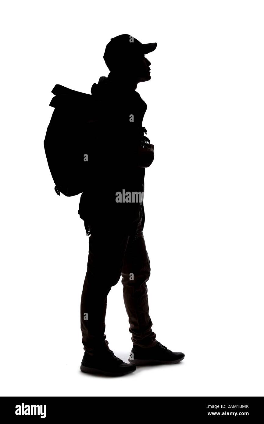 Silhouette of a man hiking and carrying a backpack on a white ...