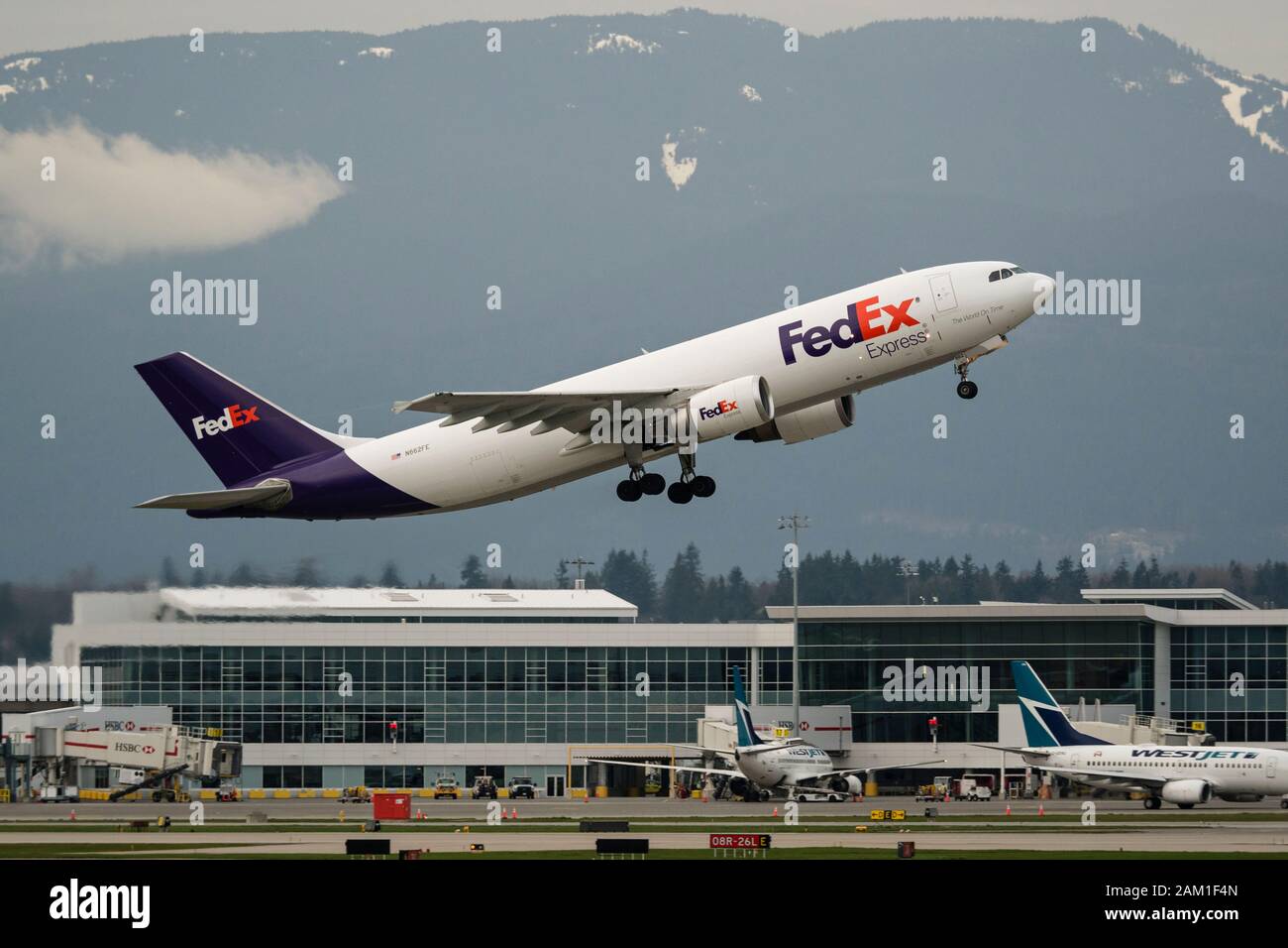 A FedEx Airbus A300 (A300F4-605R) air cargo freighter takes off from Vancouver International Airport Stock Photo