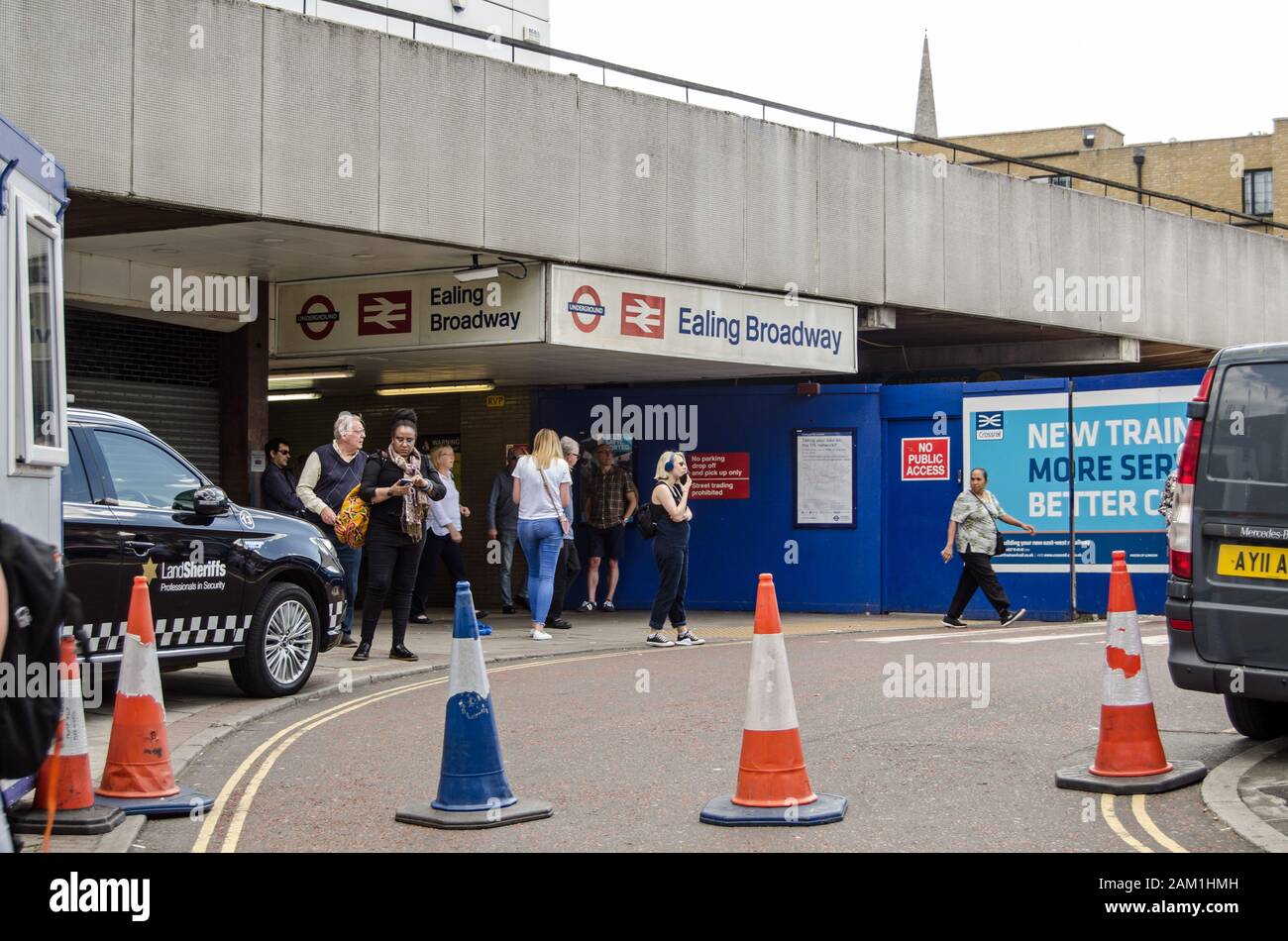 London, UK - June 22, 2019: Passengers at the truly unappealing entrance to Ealing Broadway Station in West London. Both mainline and underground serv Stock Photo